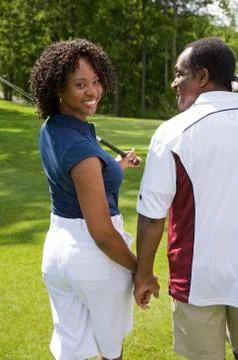 Backview of Couple Walking on Golf Course Stock Photos
