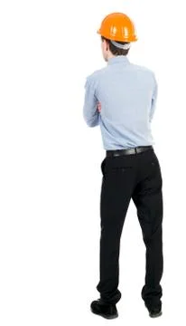 Backview of an engineer in construction helmet stands Stock-Fotos