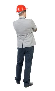 Backview of an engineer in construction helmet stands Foto stock