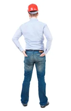 Backview of an engineer in construction helmet stands Foto stock