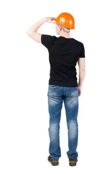 Backview of an engineer in construction helmet stands Stock Photos