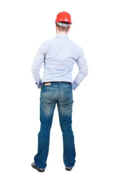 Backview of an engineer in construction helmet stands Foto stock