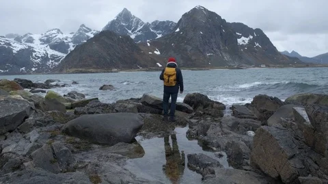 Backview of one lonely guy by the going and look around on the beauty pictures Stock Footage 109379547