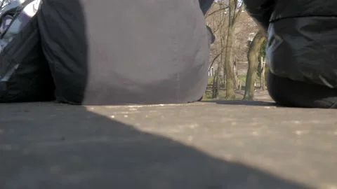 BACKVIEW PEOPLE SIT AT A PARK Stock Footage 171581214