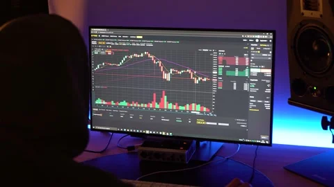 Backview of a trader looking at financial chart trading bitcoin and Stock Footage 149544997