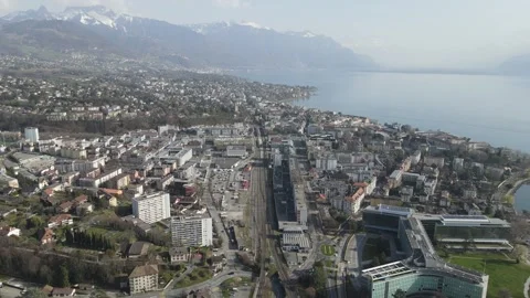 Backward aerial drone view over Vevey train station and Lake Geneva Stock Footage 330359647