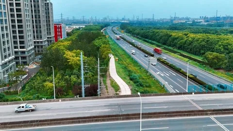 Backward Aerial View of Highway Traffic and Urban Overpass 動画素材 341601285