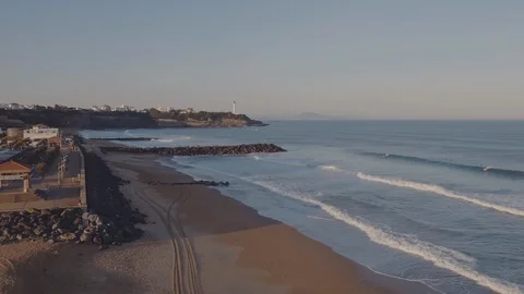 Backward camera movement over yellow sand beach and little waves of blue sea or Stock-Footage 108611988
