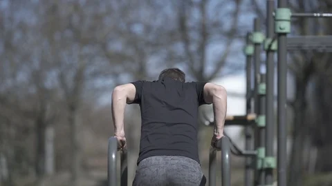 Backward dips on the bars, stock video Stock Footage 105594762