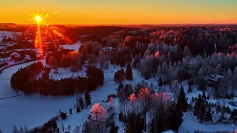 Backward Drone Dolly Over Snowy Forest at Golden Sunset Stock Footage 328990802