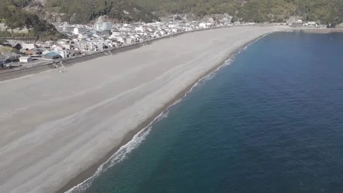 Backward Drone Flight with Diagonal Shoreline and Calm Sea Stock Footage 326179768
