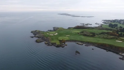Backward drone flight of golf course next to the sea Video stock 127003294