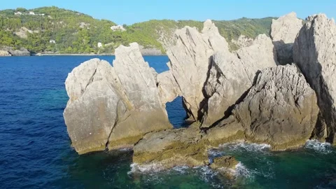 Backward Drone Flight from the Natural Arch at Rocky Islet Surrounding the Water Video stock 315073744