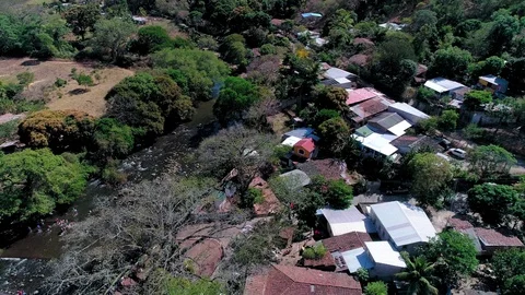Backward drone flight over  buildings next to a river 01 Stock Footage 101307347