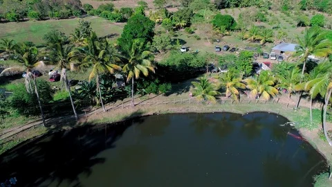 Backward drone flight over a lagoon and public pool in Central America 01 Stock Footage 101318991