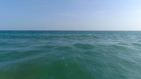 Backward Drone flight over the ocean and waves Stock Footage 98618145