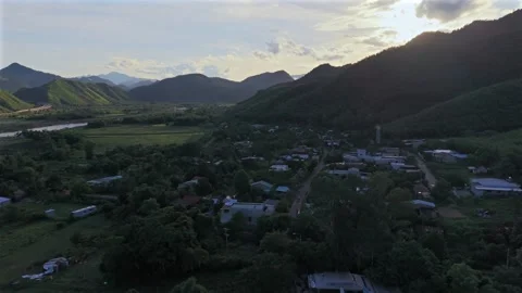 Backward drone flight over rural mountain village at sunset in Da Nang Vietnam Stock Footage 337948286