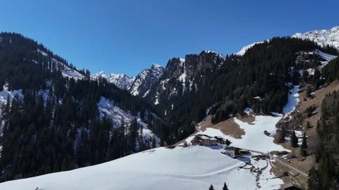 Backward Drone Flight Revealing Snowy and Forested Mountains in South Ty 库存影片 336941286
