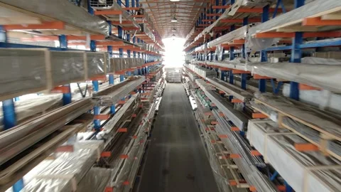 Backward drone flight through aluminum storage racks Stock Footage 326218987