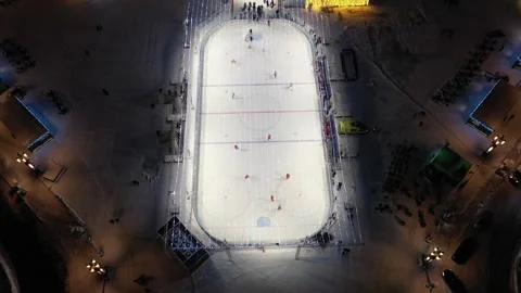 Backward drone pull with upward tilt over hockey rink Stock Footage 323000768