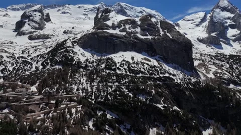 Backward Drone Pullout From Rugged Mountain Cliff to Reveal Snowy Valley Stock Footage 339529009