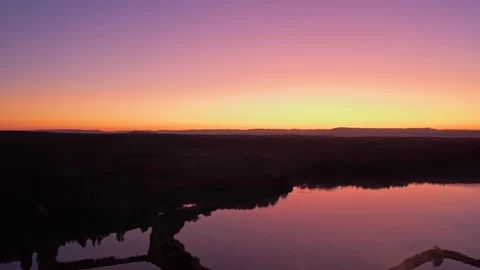 Backward flight over artificial pond before sunrise, 4k Stock Footage 116424256