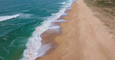 Backward flight over the beach of Nazare portugal on a sunny day, 4k dci Stock Footage 303284911