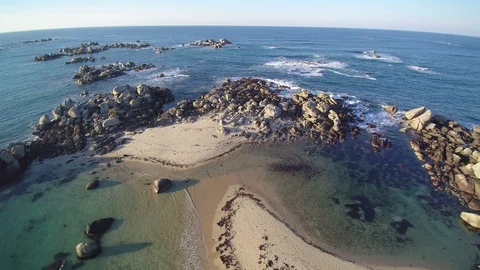 Backward flight over a coastal tip on Atlantic ocean. 4K footage - 1 of 3. Stock Footage 86476257