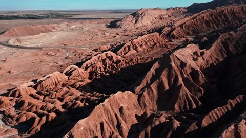 Backward flight over dramatic eroded salt rock ridges and ravines of the Stock Footage 336266157