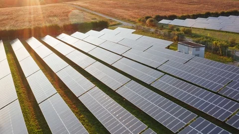 Backward flight over a field of solar panels in the afternoon, 4k Stock Footage 115935496