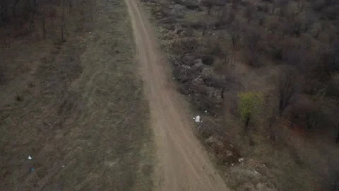 Backward flight over mud road aerial 4K video Stock Footage 99816784