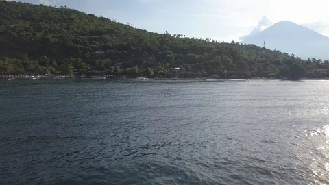 Backward flight over ocean water with coastline on background Video stock 94152087