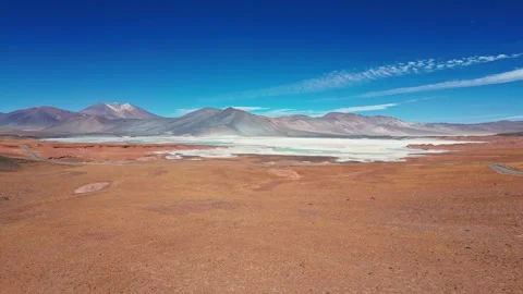 Backward flight over vast red arid desert plain distancing from iconic Stock Footage 336265894