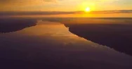 Backward Flying Aerial Reveal Of Vast River At Sunrise Stock Footage