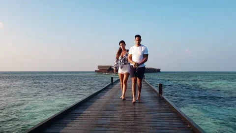 Backward low angle exotic water villas resort maldives tourists Stock Footage 280796779