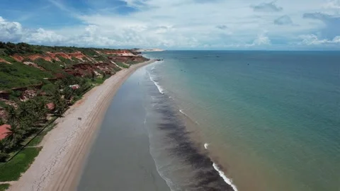 Backward motion with Drone on small paradisiacal beach with green sea and Stock Footage 240896797