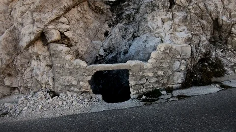 Backward moving tilt up old stone water drain in Julian Alps mountains Stock Footage 122211919