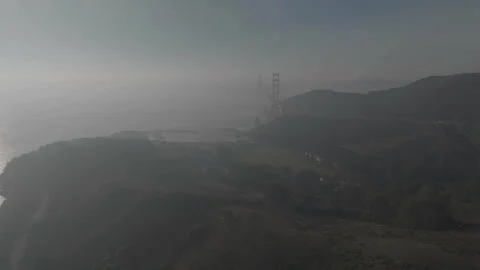 Backward tracking drone from San FranciscoF bridge to hill Stock Footage 336792941