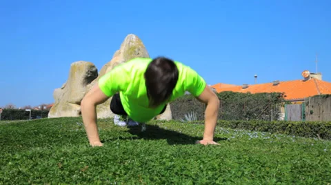 Backwards dolly shot of man doing pushups Stock Footage 37903198