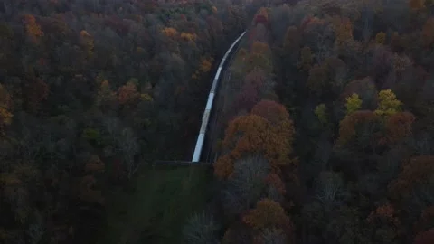 A Backwards Drone Flight Showing a Freight Train in the Fall 库存影片 188526939