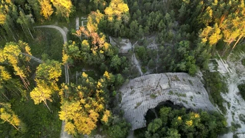 Backwards drone flight into sunset over lost place old nazi airport bunker Stock Footage 250238522