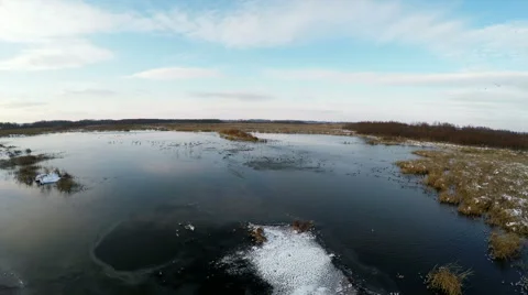 Backwards flight over frozen marsh land Stock Footage 52247750