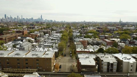 Backwards Flight over Northside Chicago Neighborhood. Skyline in Background Video stock 153122891