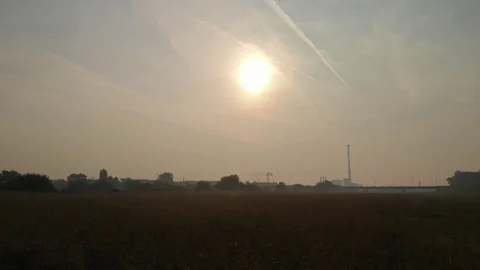 Backwards flight over park with sun in background Stock Footage 115722173