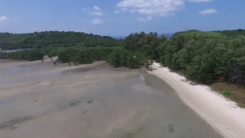 Backwards flying over a low tide beach Stock Footage 80371981