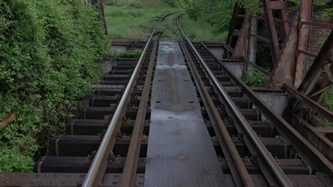 Backwards flying over the old style bridge with railway track 4K drone Stock Footage 113871579