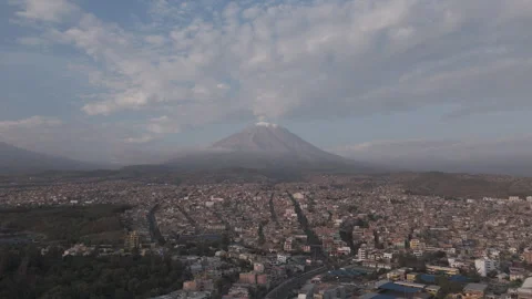 Backwards moving drone shot above Arequipa Peru with view on the mountain near Stock Footage 303199465
