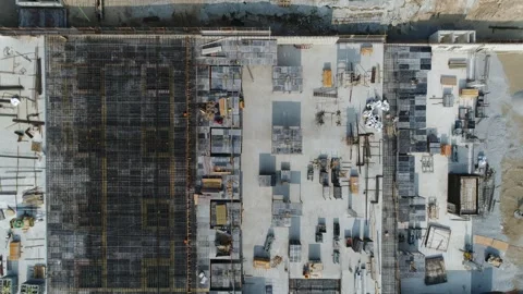 Backwards Top Down Aerial Over Building Foundation With Construction Materia Stock-Footage 250417409