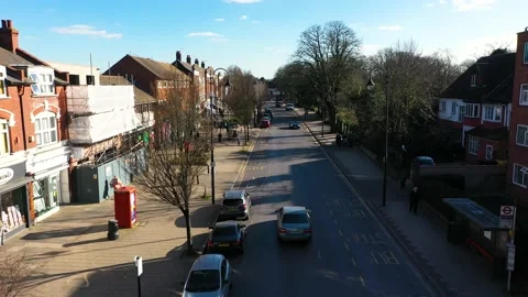 BACKWARDS TOP SHOT OF MOVING VEHICLES ON CITY ROAD Stock-Footage 149856437