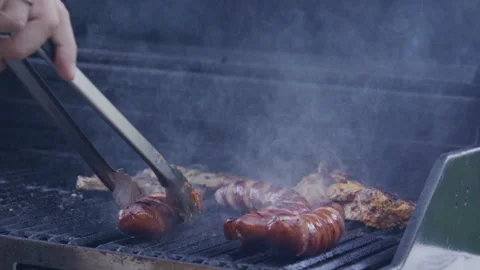 Backyard BBQ. Man cook steak meat, slow motion. Man with barbeque roast meat Stock Footage 346185591